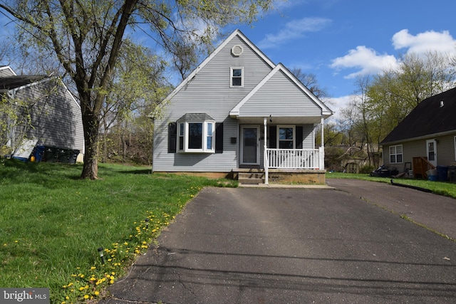 bungalow featuring a front lawn and covered porch