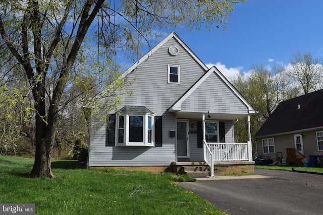bungalow-style house with a porch and a front lawn