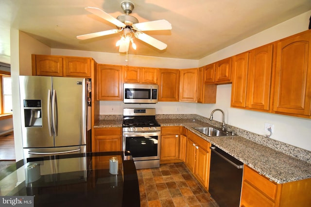 kitchen with a sink, brown cabinetry, and appliances with stainless steel finishes