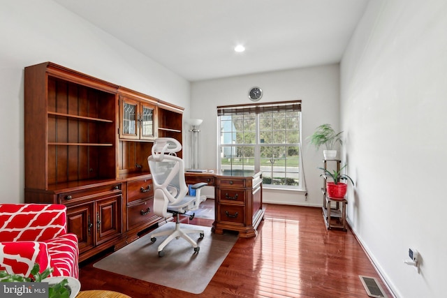 office space with visible vents, wood finished floors, and baseboards