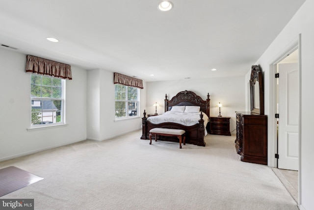 bedroom featuring recessed lighting, visible vents, light carpet, and baseboards