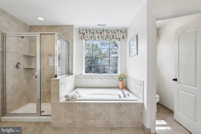 full bath with tile patterned floors, a shower stall, toilet, and a garden tub