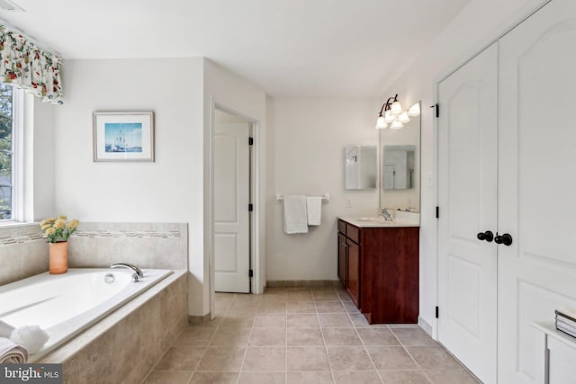 full bathroom featuring tile patterned floors, a bath, and vanity