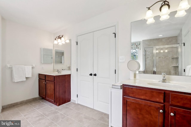 bathroom with two vanities, a shower stall, tile patterned flooring, and a sink