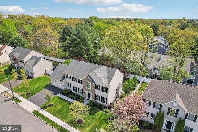 bird's eye view featuring a view of trees and a residential view