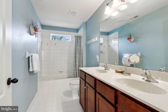 full bathroom featuring toilet, tile patterned flooring, a sink, and double vanity