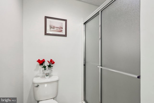 full bath with an enclosed shower and toilet