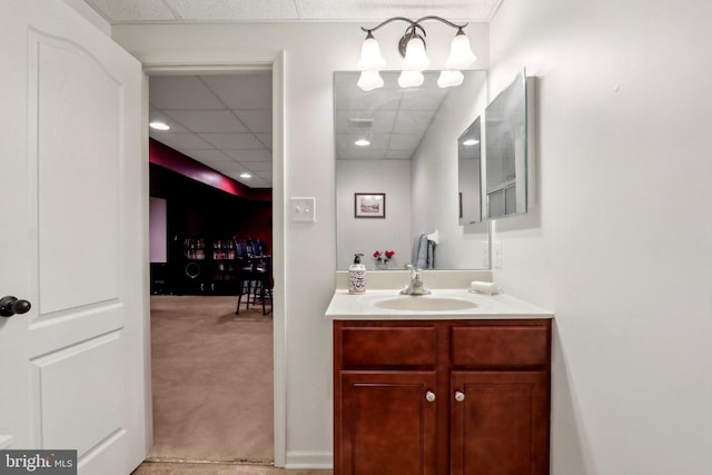 bathroom featuring a drop ceiling, vanity, and visible vents