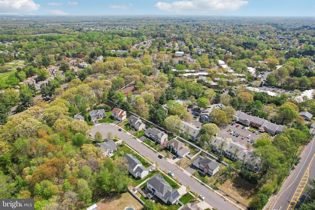 birds eye view of property featuring a wooded view and a residential view