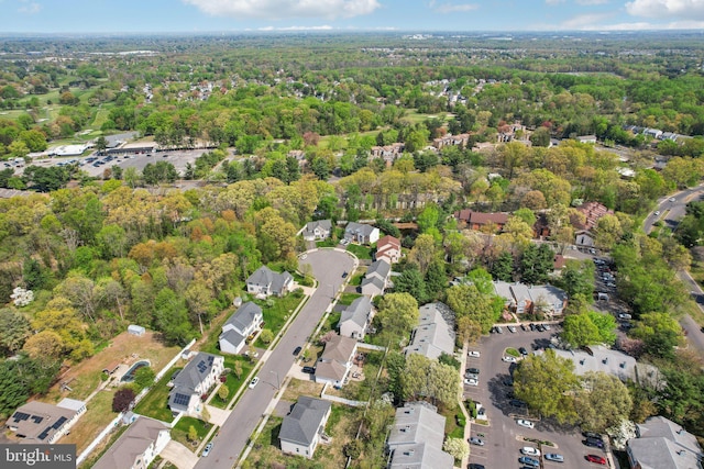 aerial view featuring a wooded view and a residential view