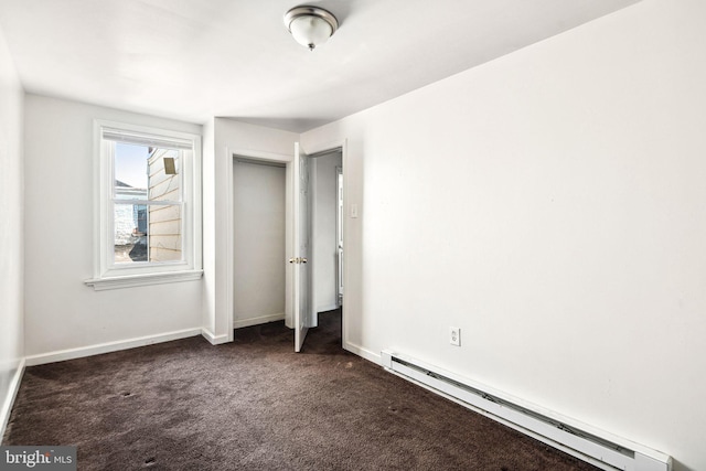 2333 E Huntingdon St, Philadelphia, PA 19125 - unfurnished bedroom featuring baseboard heating, a closet, dark colored carpet, and baseboards