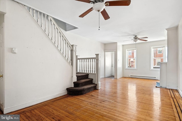 2333 E Huntingdon St, Philadelphia, PA 19125 - unfurnished living room featuring baseboards, a ceiling fan, stairs, light wood-style floors, and a baseboard radiator