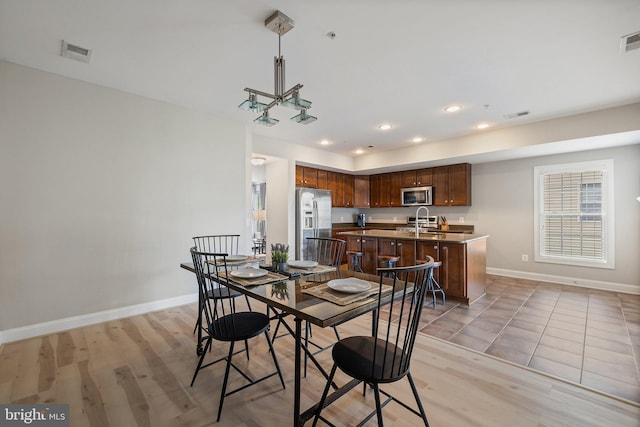 dining space featuring baseboards, recessed lighting, and visible vents