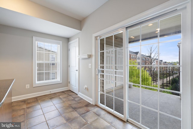 doorway to outside featuring baseboards