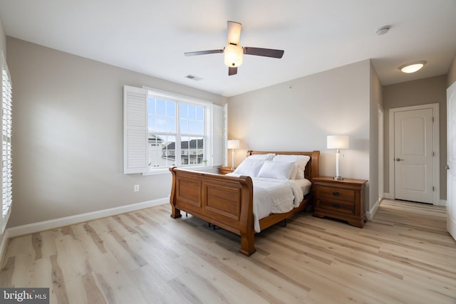 bedroom with ceiling fan, baseboards, visible vents, and light wood-style flooring
