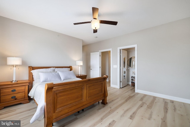 bedroom featuring a ceiling fan, baseboards, and light wood-style flooring