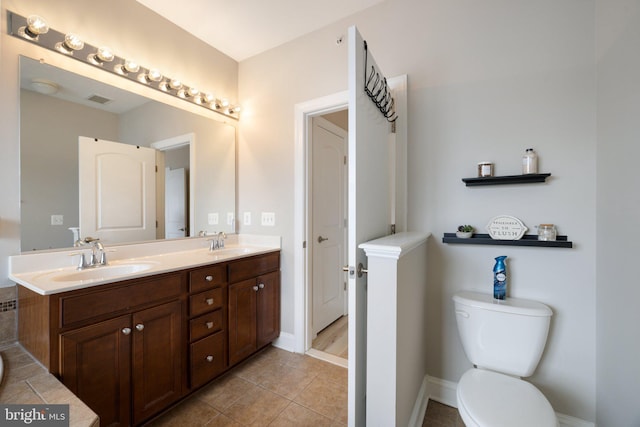 full bath with baseboards, a sink, and tile patterned floors