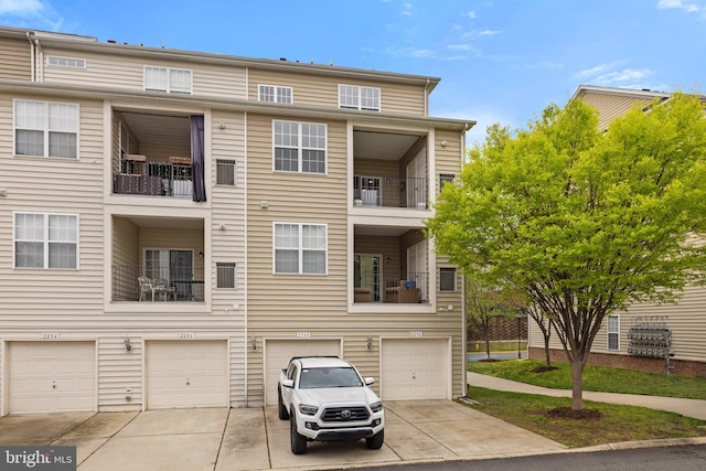 townhome / multi-family property with driveway and a garage
