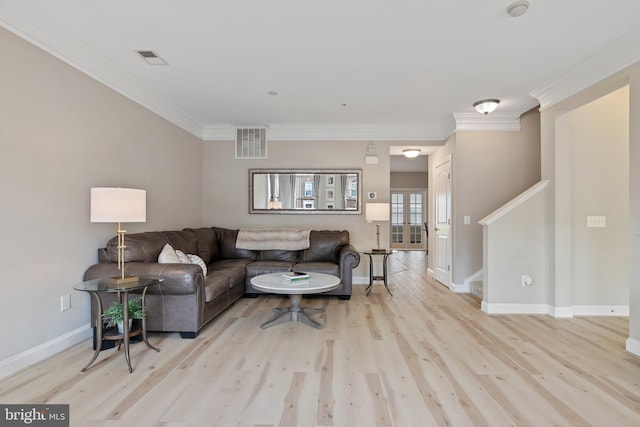 living room featuring baseboards, ornamental molding, wood finished floors, and visible vents