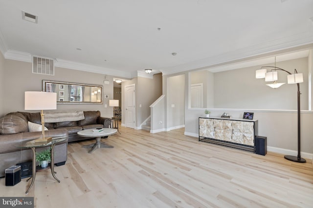 living area featuring ornamental molding, stairs, wood finished floors, and visible vents