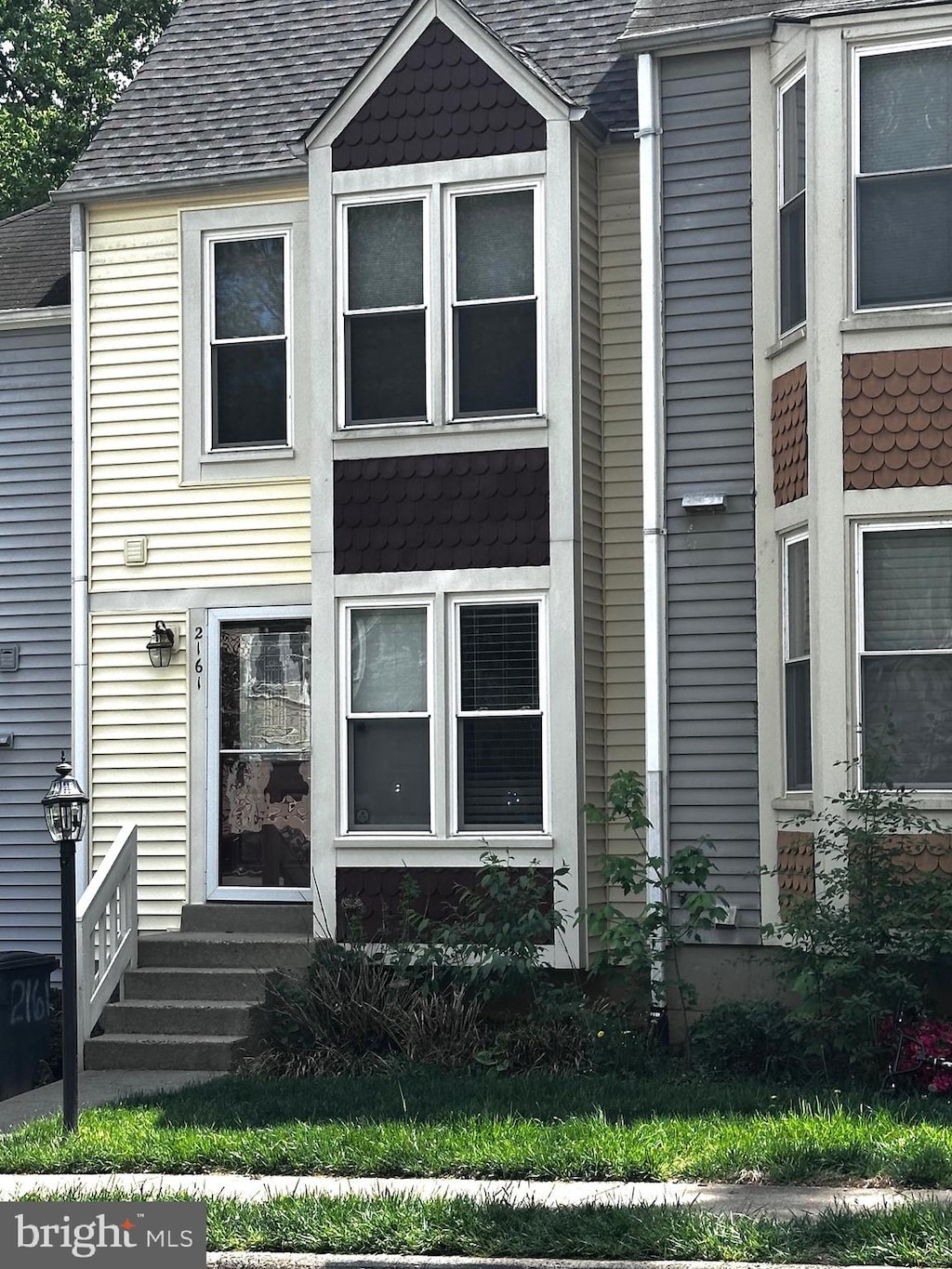 view of front of house featuring a shingled roof and entry steps