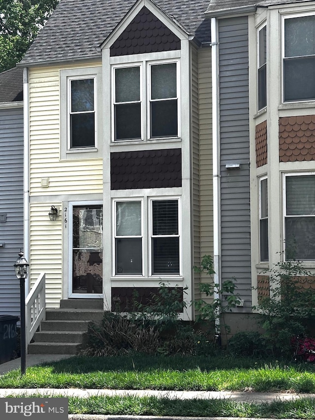 view of front of house featuring a shingled roof and entry steps