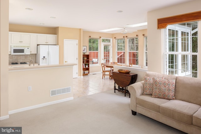 1432 Quaker Rdg, West Chester, PA 19380 - living area featuring visible vents, ceiling fan, baseboards, and light carpet