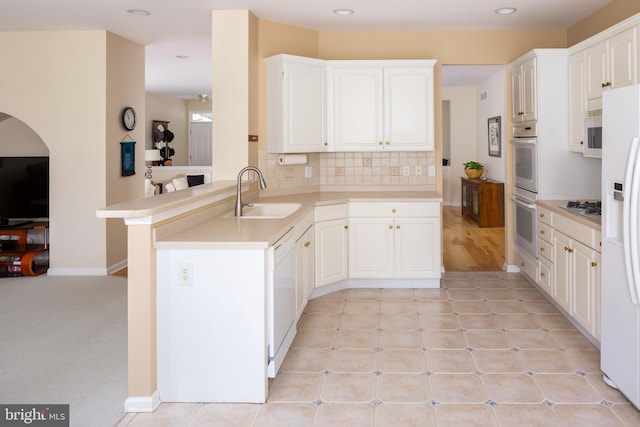 1432 Quaker Rdg, West Chester, PA 19380 - kitchen with a sink, white appliances, a peninsula, light countertops, and white cabinets