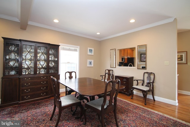 dining space with recessed lighting, wood finished floors, baseboards, and ornamental molding