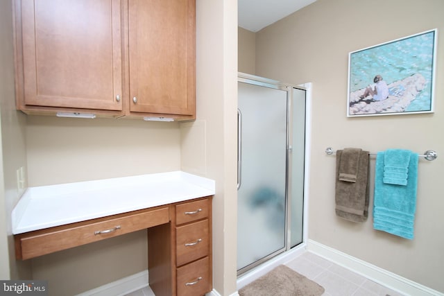 full bath with a shower stall, tile patterned floors, and baseboards