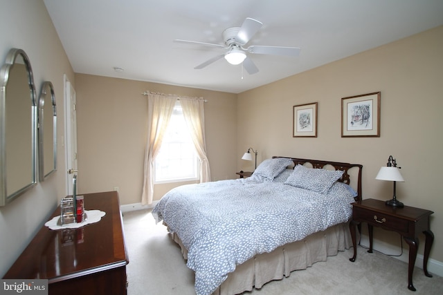 carpeted bedroom featuring a ceiling fan and baseboards