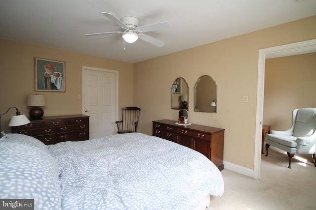 bedroom featuring a ceiling fan, baseboards, and light colored carpet