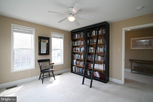 sitting room with ceiling fan, baseboards, carpet flooring, and visible vents
