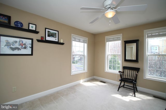 unfurnished room featuring visible vents, a ceiling fan, baseboards, and carpet