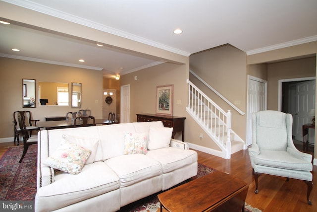 living area with stairs, ornamental molding, wood finished floors, and recessed lighting