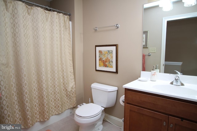 full bathroom with baseboards, vanity, tile patterned flooring, and toilet