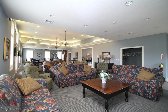 living area featuring recessed lighting, carpet, visible vents, and a tray ceiling