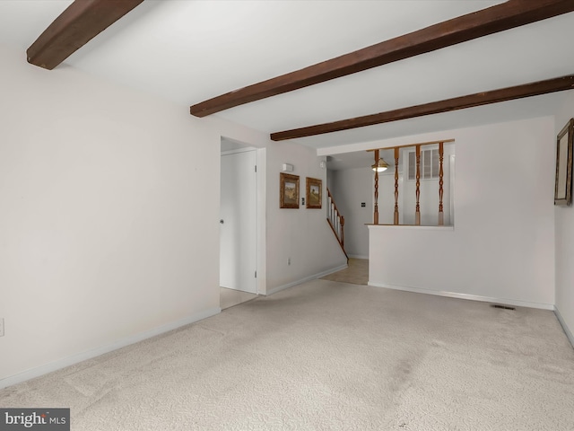 unfurnished living room featuring carpet, baseboards, stairway, and beamed ceiling
