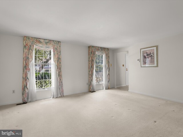 empty room featuring carpet flooring and visible vents
