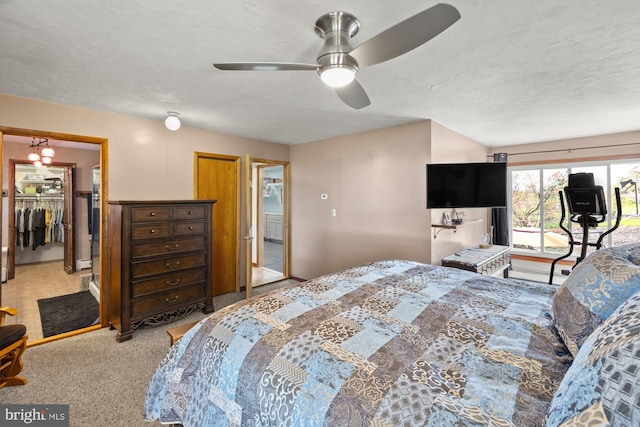 bedroom with ceiling fan with notable chandelier and carpet flooring