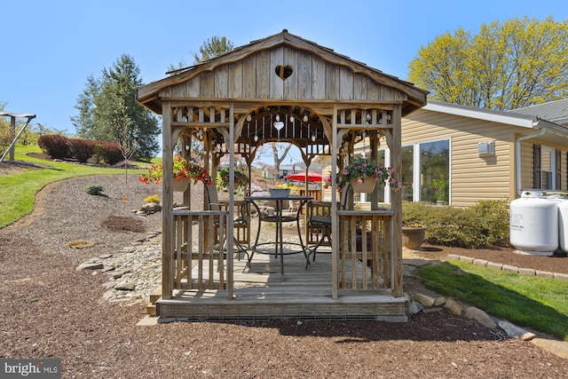 deck featuring outdoor dining area and a gazebo