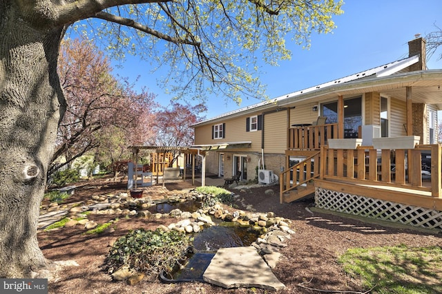 back of house with a chimney, a wooden deck, brick siding, and a pergola