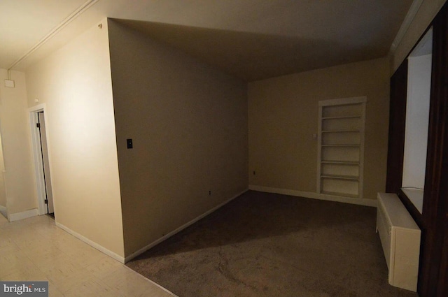 interior space with baseboards and built in features