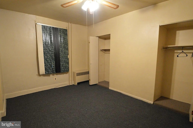 unfurnished bedroom with dark colored carpet, ceiling fan, radiator, and baseboards