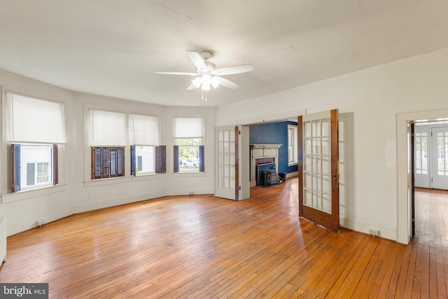5342 Main St, Stephens City, VA 22655 - unfurnished living room featuring french doors, light wood-style floors, ceiling fan, and baseboards