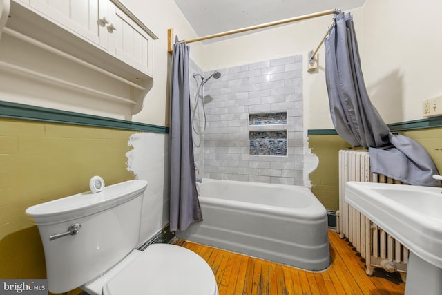 5342 Main St, Stephens City, VA 22655 - full bath featuring hardwood / wood-style floors, radiator, shower / bath combination with curtain, toilet, and a sink