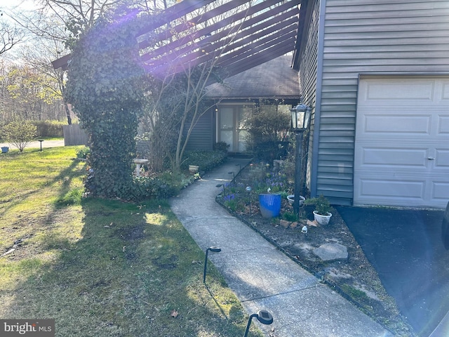 view of property exterior featuring a garage and a yard