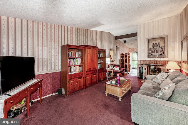 living room featuring wallpapered walls, a textured ceiling, lofted ceiling, carpet, and a fireplace
