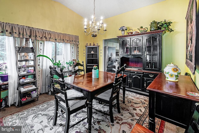 dining space featuring a chandelier and lofted ceiling