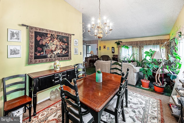 dining room with a textured ceiling and a chandelier
